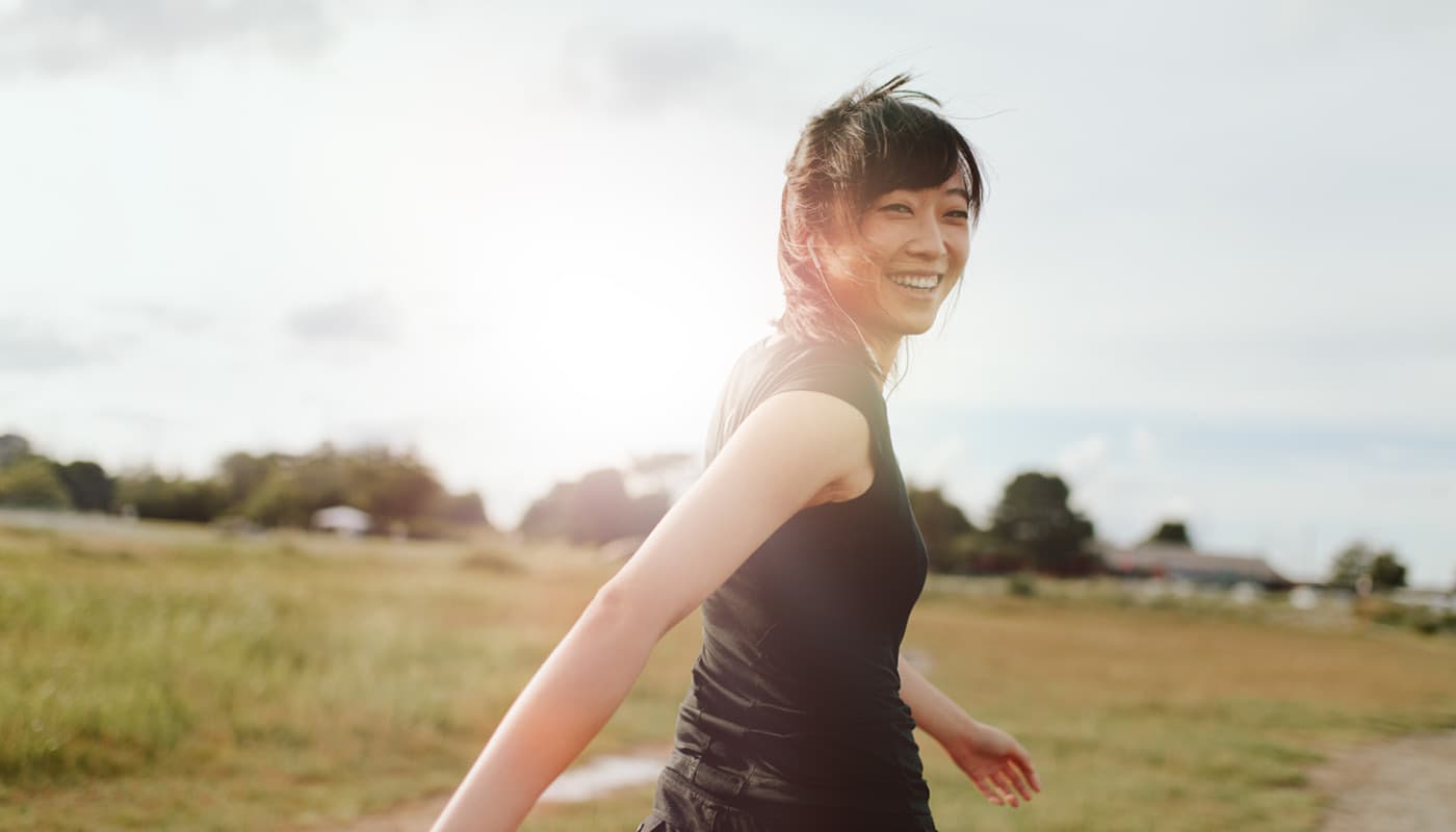 happy woman walking turns around and smiles